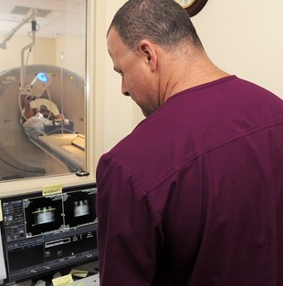 MRI machine for lung cancer screening and males tech reading image.