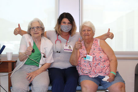 Photo of our one of our nurses with 2 patients.