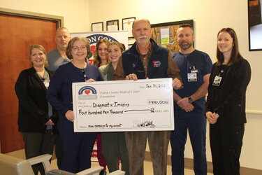 foundation members with large check for 410,000 dollars
