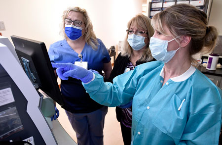 Three of our staff members discussing lab results