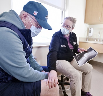 Patient viewing xray with provider in an exam room